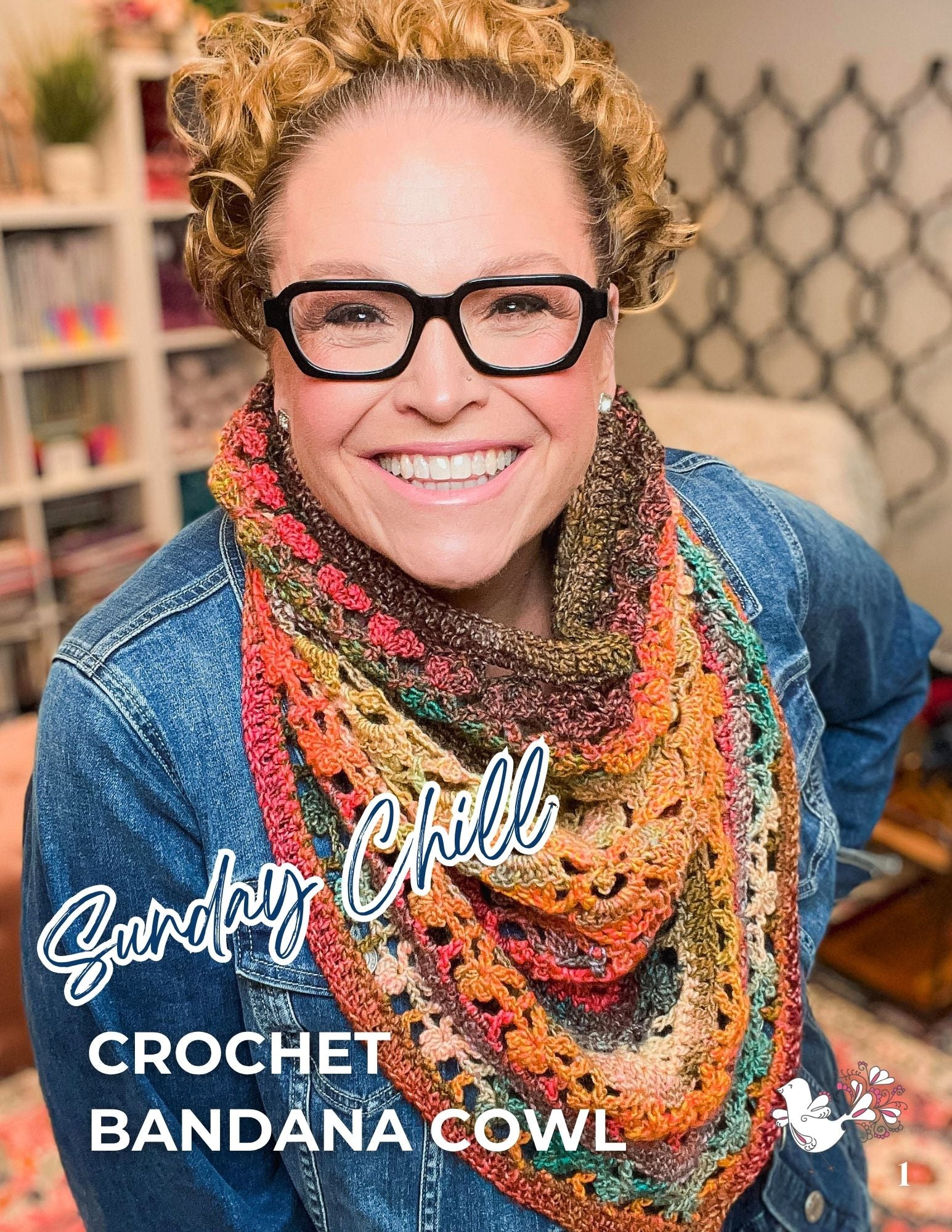 A smiling person wearing glasses models the Sunday Chill Crochet Bandana Cowl Pattern—a vibrant, lacy shell stitch accessory paired with a denim jacket. Cozy and creative indoor surroundings, featuring books and yarn, highlight the warmth and charm of this textured crochet bandana cowl. Text reads “Sunday Chill Crochet Bandana Cowl Pattern.”.