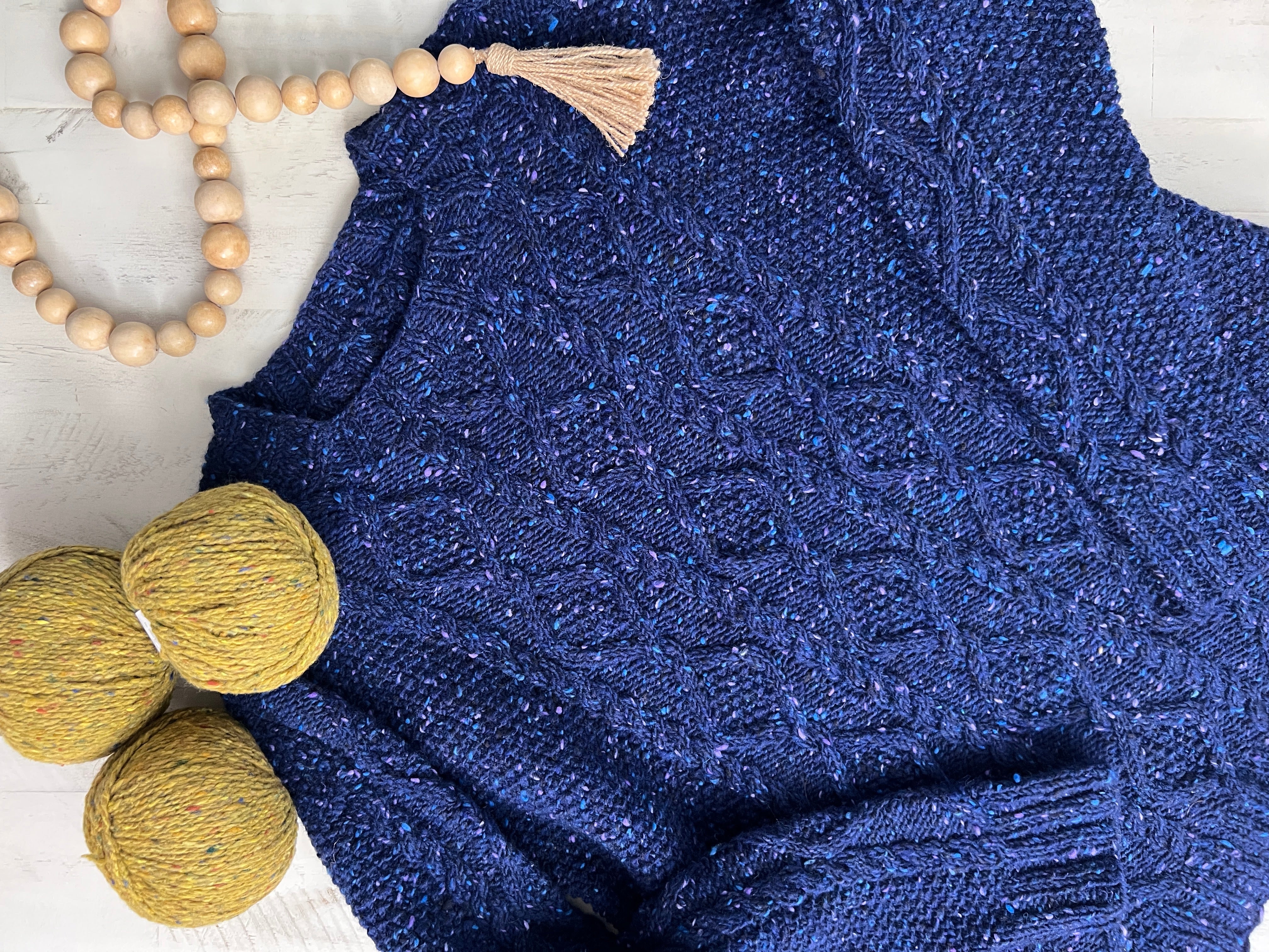 Overland Trail cabled knit sweater in blue tweed wool, saddle shoulder construction. Flat View