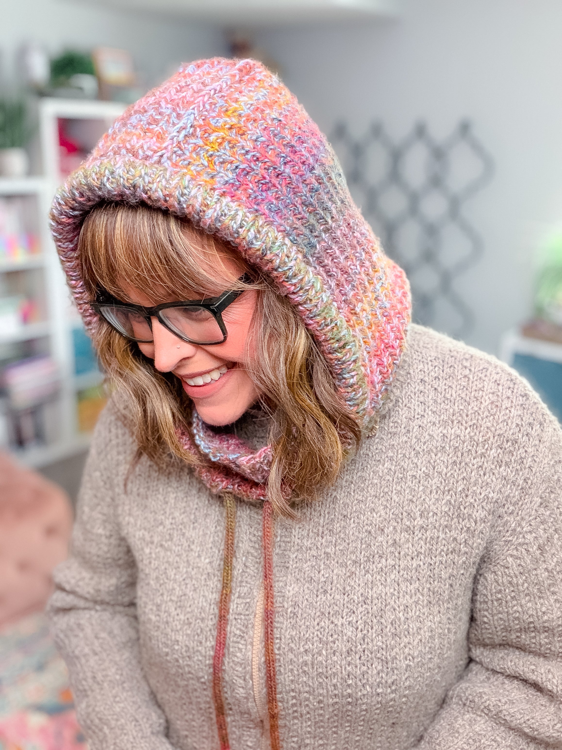 A person wearing a Cozy Sideline Knit Balaclava - PDF with drawstring ties.