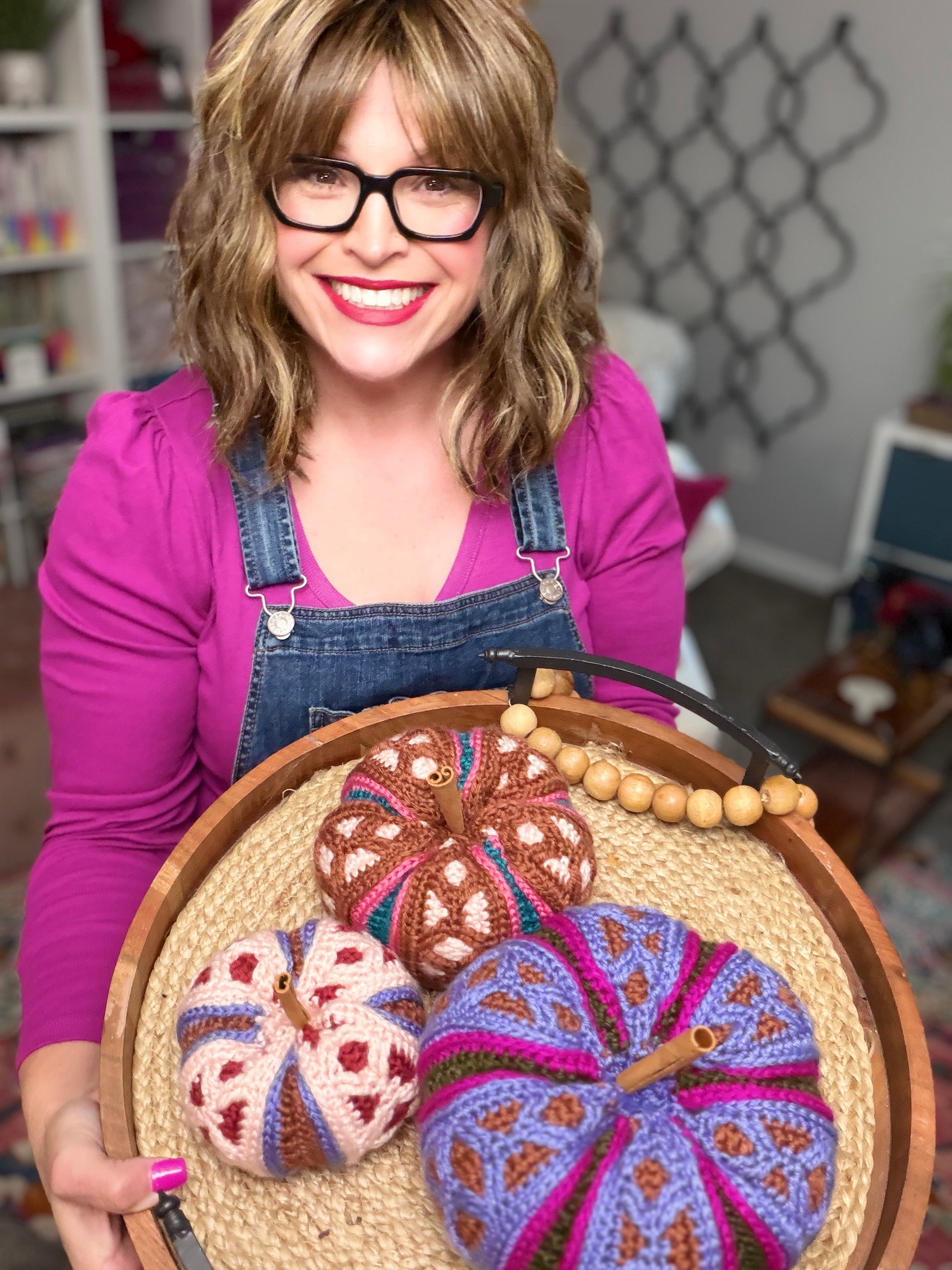 Stacked trio of mosaic crochet pumpkins in pink, brown, and purple colorways