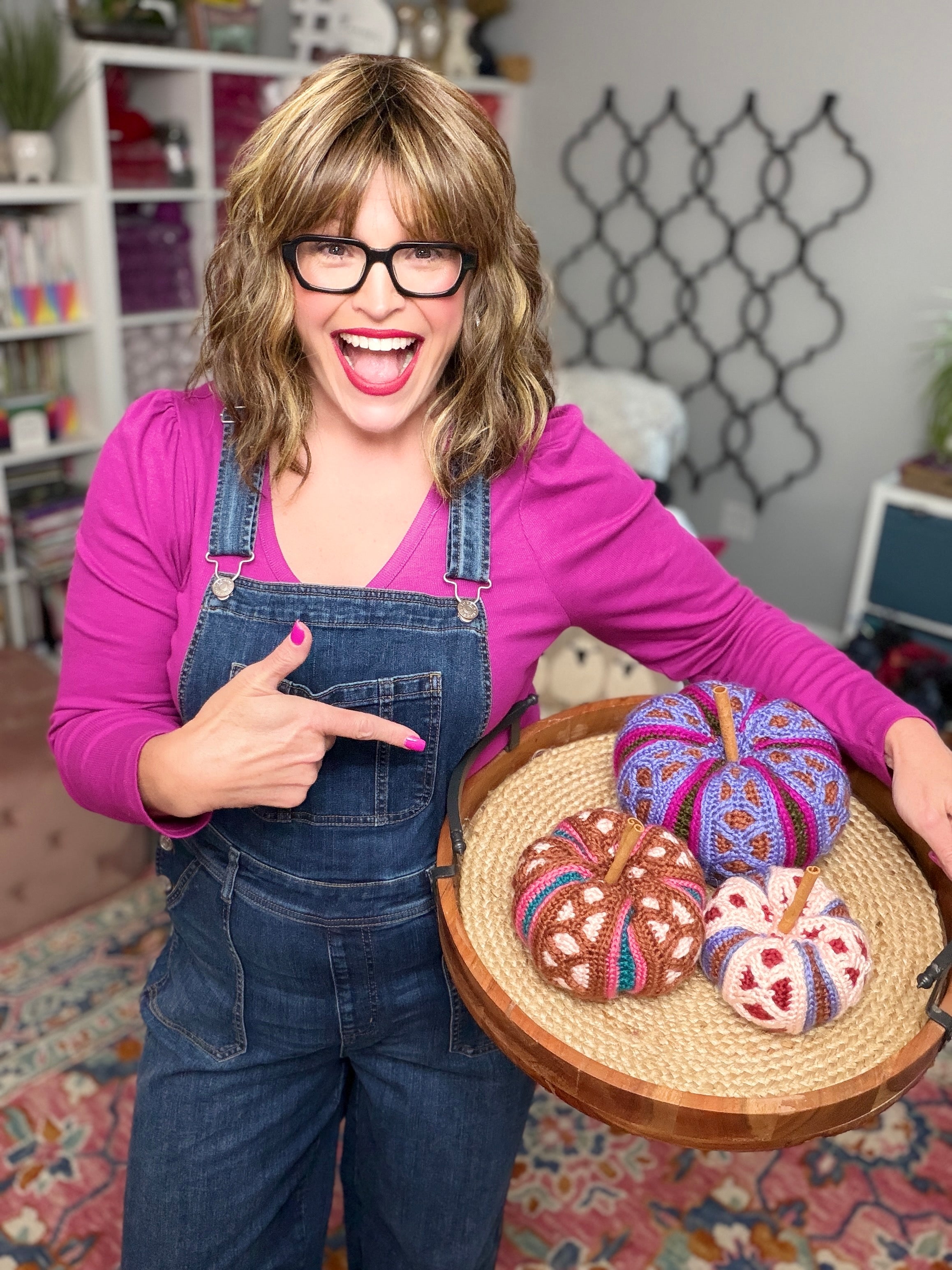 Stacked trio of mosaic crochet pumpkins in pink, brown, and purple colorways