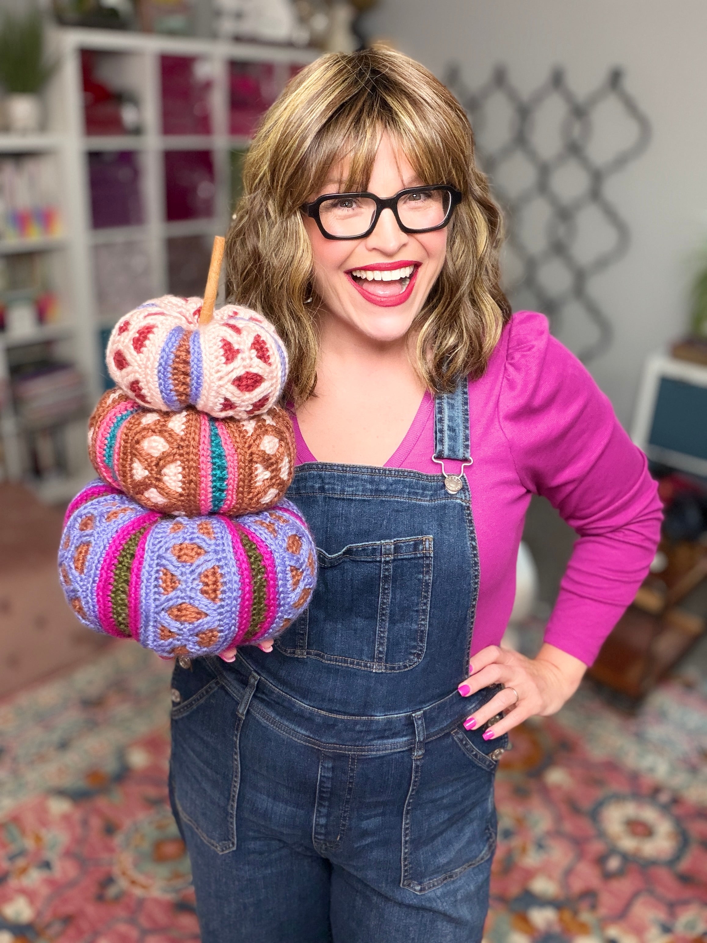 Stacked trio of mosaic crochet pumpkins in pink, brown, and purple colorways