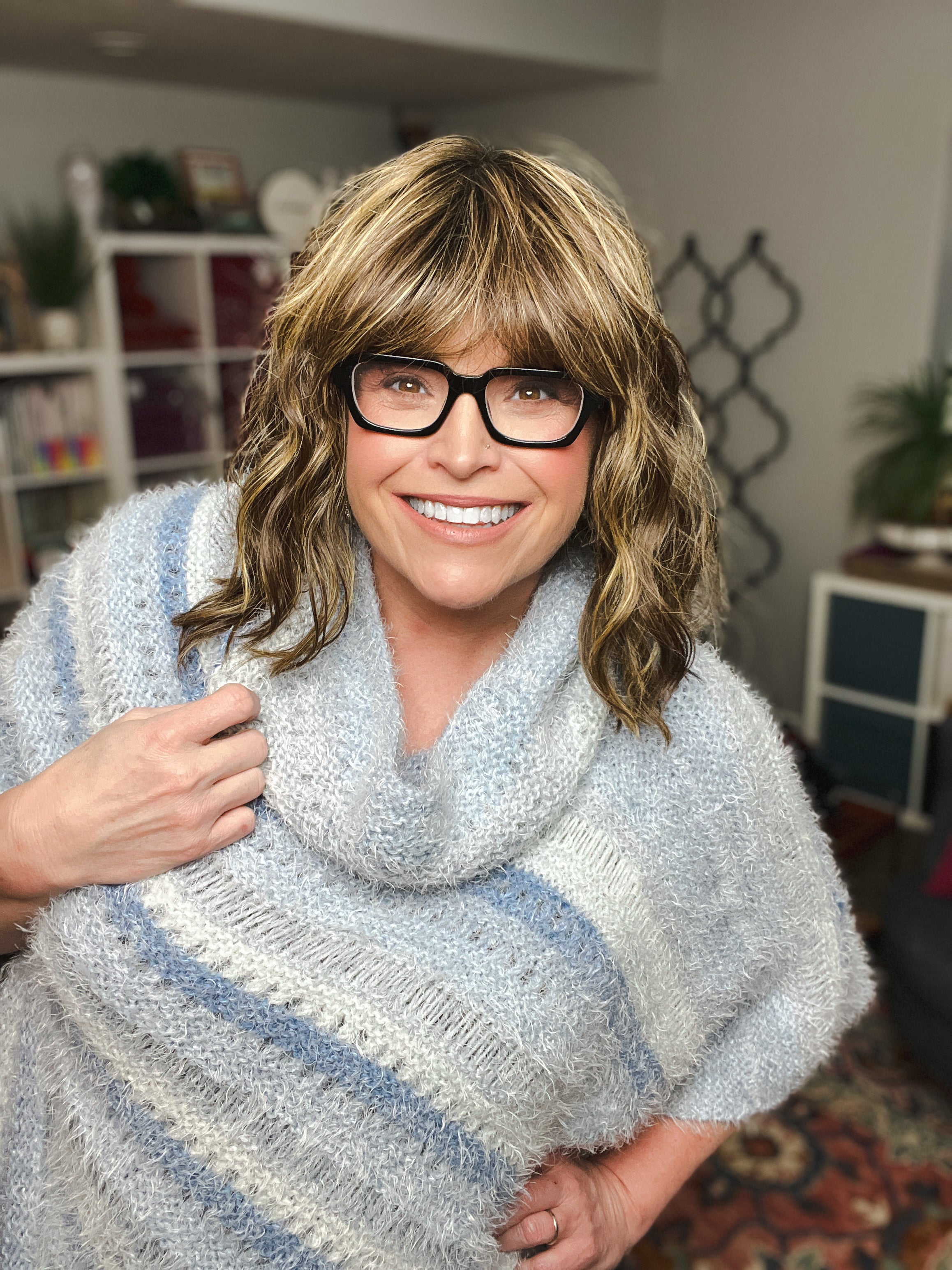 Woman wearing oversized knit poncho with relaxed fit
