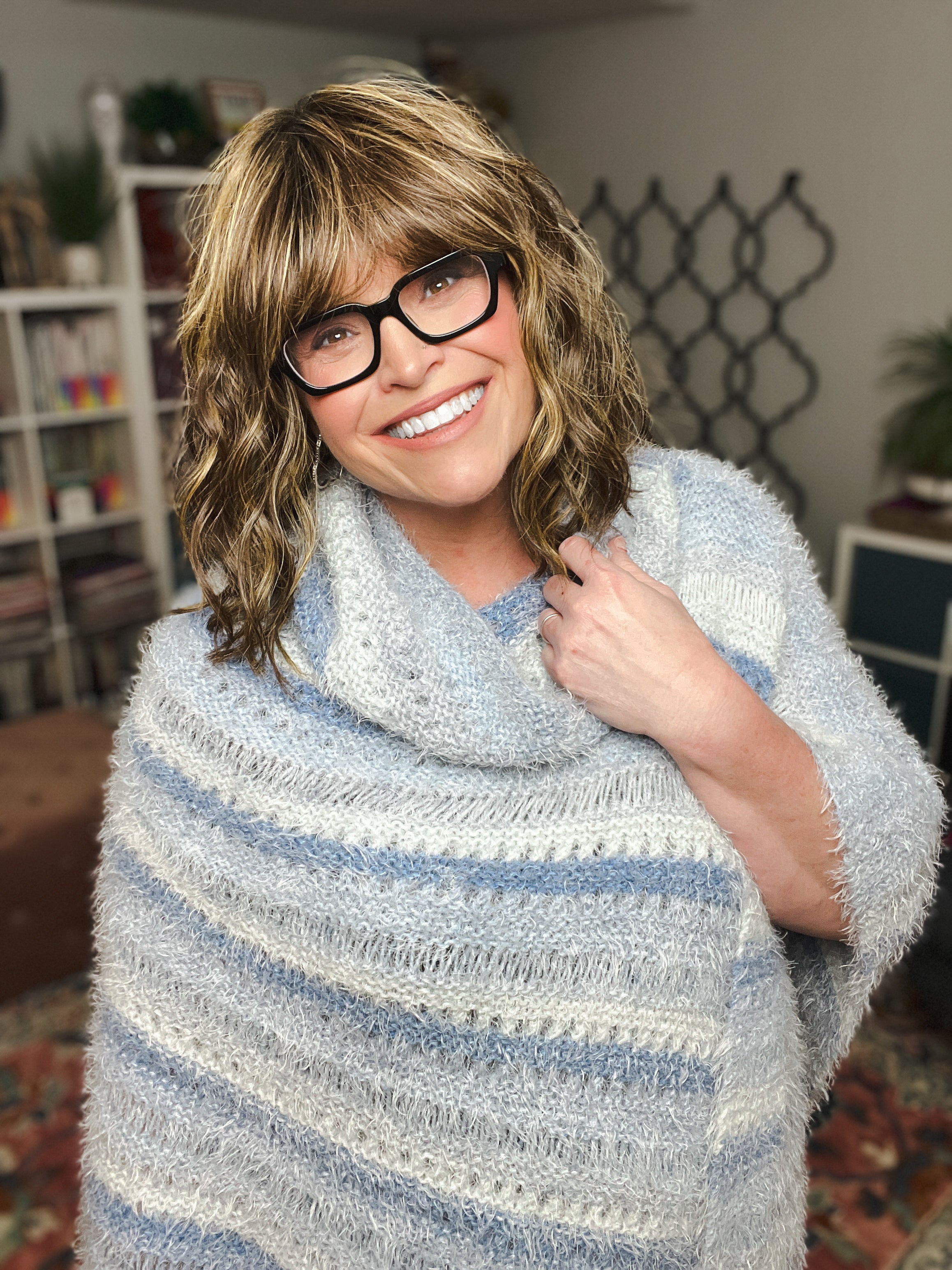 Woman wearing oversized knit poncho with relaxed fit