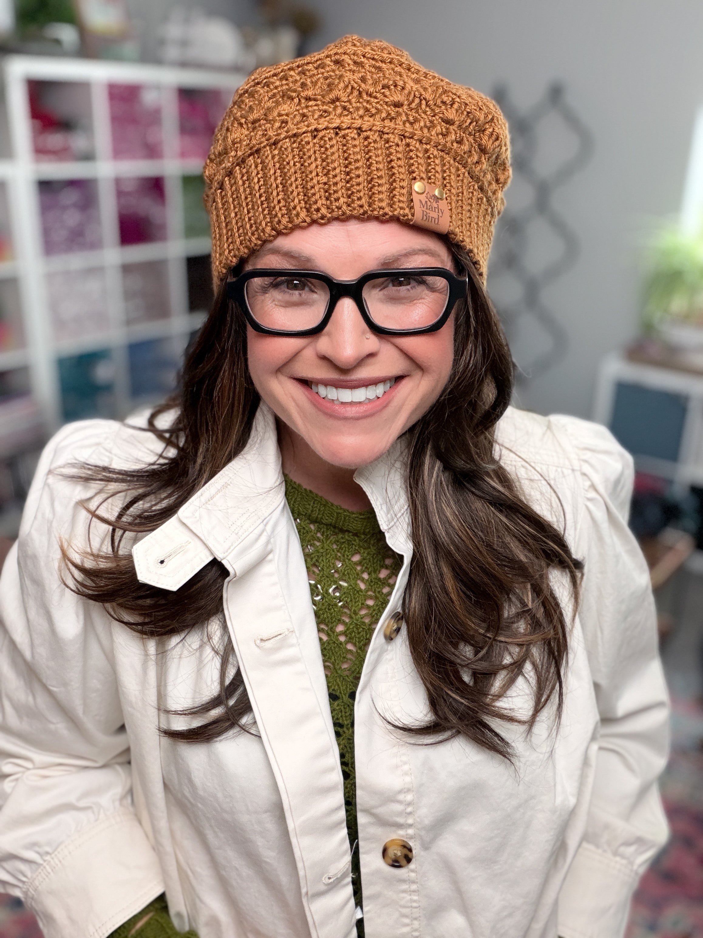 Marly Bird wearing the Toasted Marshmallow Crochet Hat, a caramel shell stitch beanie with single crochet through the back loop ribbed brim