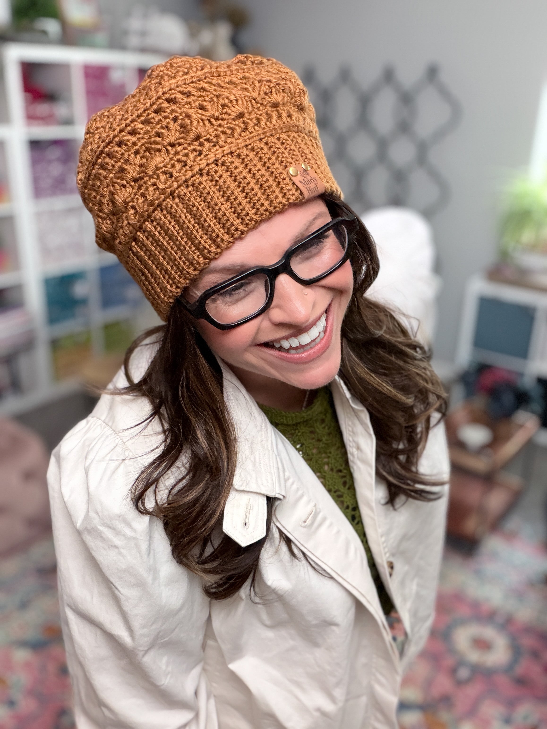 Marly Bird wearing the Toasted Marshmallow Crochet Hat, a caramel shell stitch beanie with single crochet through the back loop ribbed brim