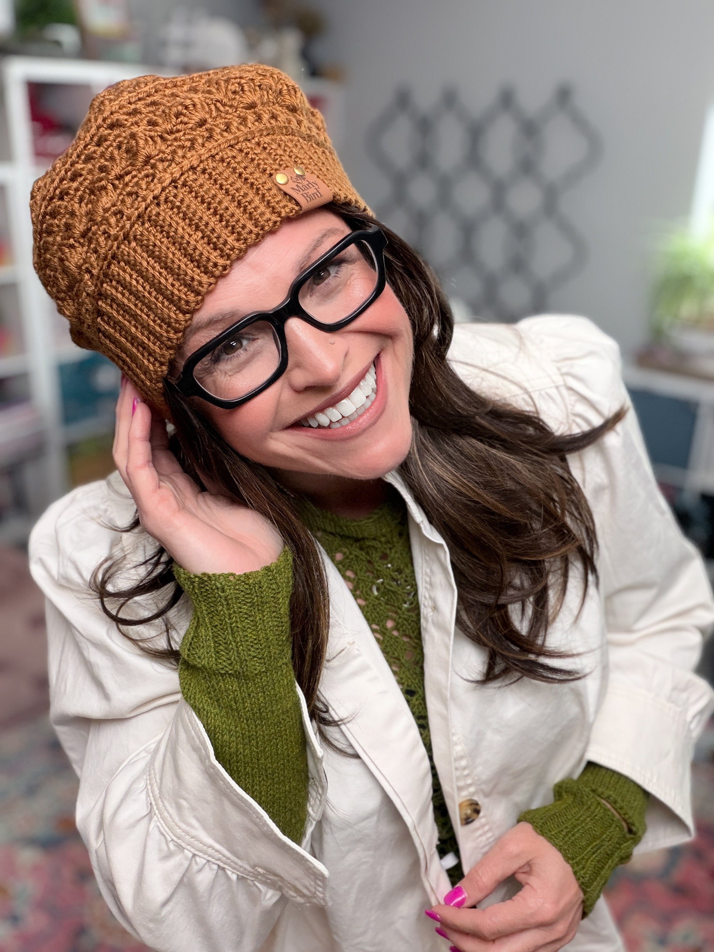 Marly Bird wearing the Toasted Marshmallow Crochet Hat, a caramel shell stitch beanie with single crochet through the back loop ribbed brim