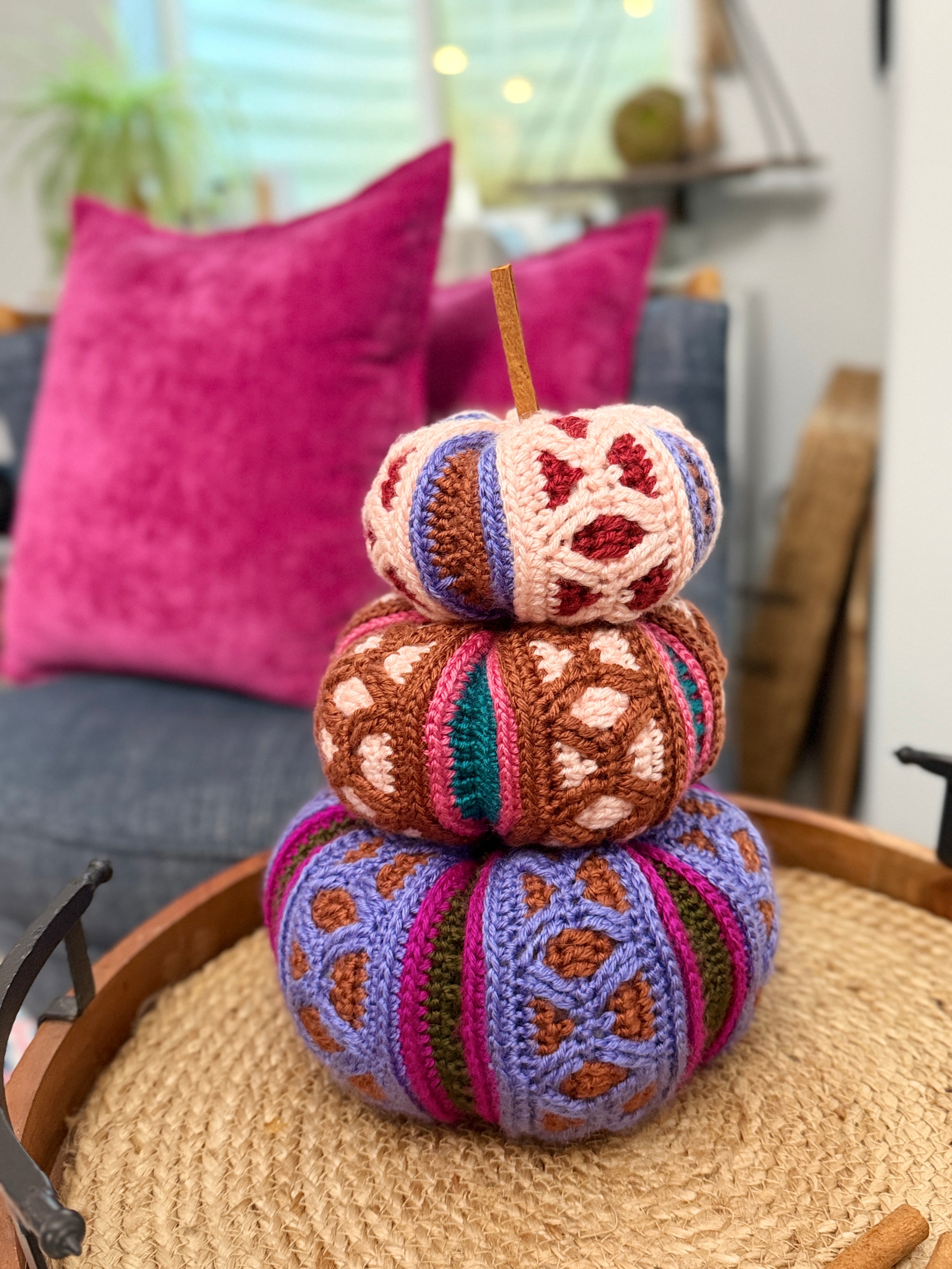 Stacked trio of mosaic crochet pumpkins in pink, brown, and purple colorways. Rockford Crochet Pumpkins by Marly Bird